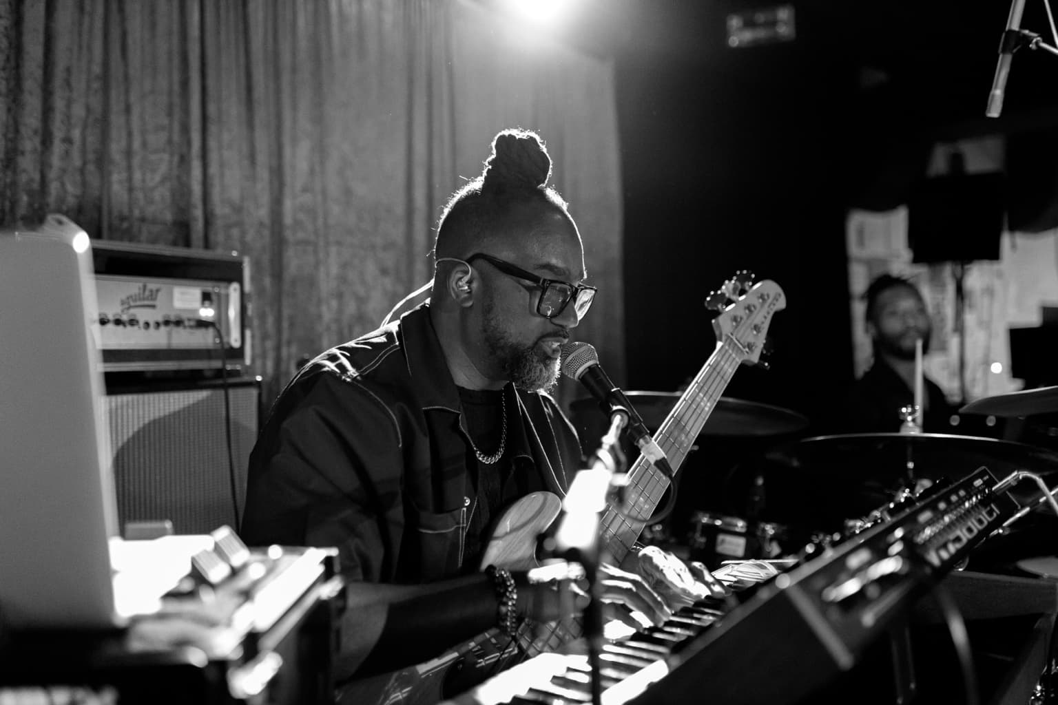 Black-and-white image of Jermaine Williams creating on bass and keys